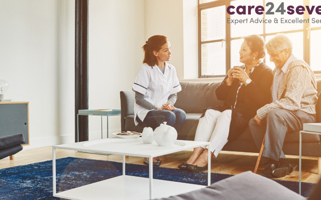 lady caring for elderly couple sat on sofa