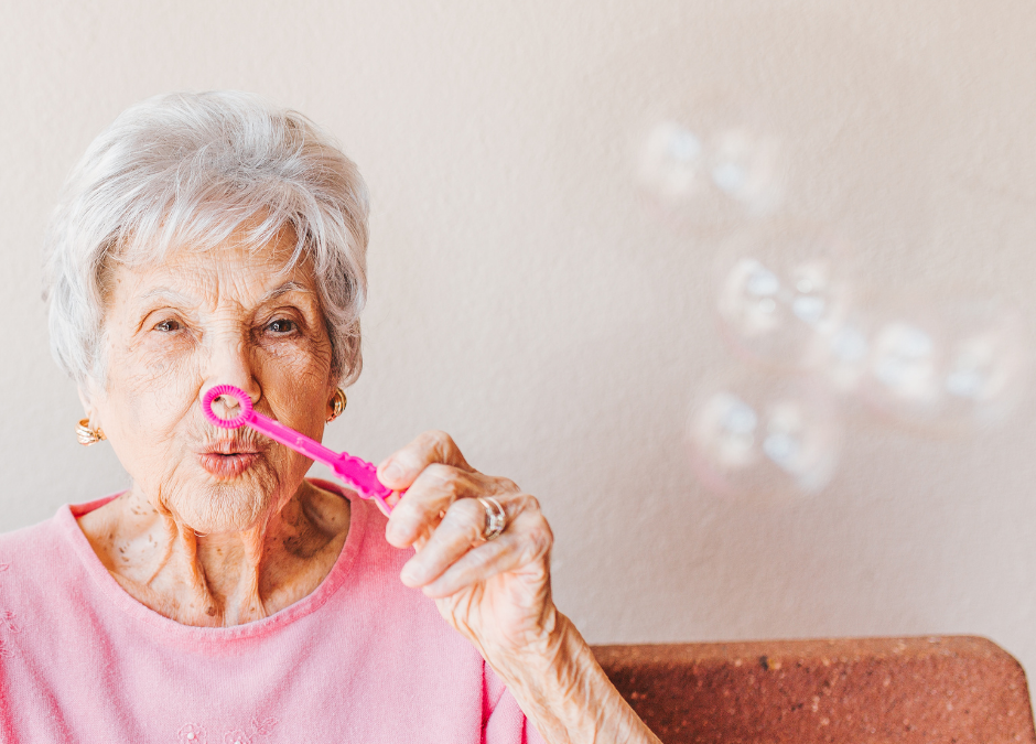 elderly lady blowing bubbles