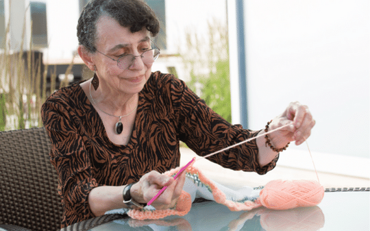 senior woman knitting